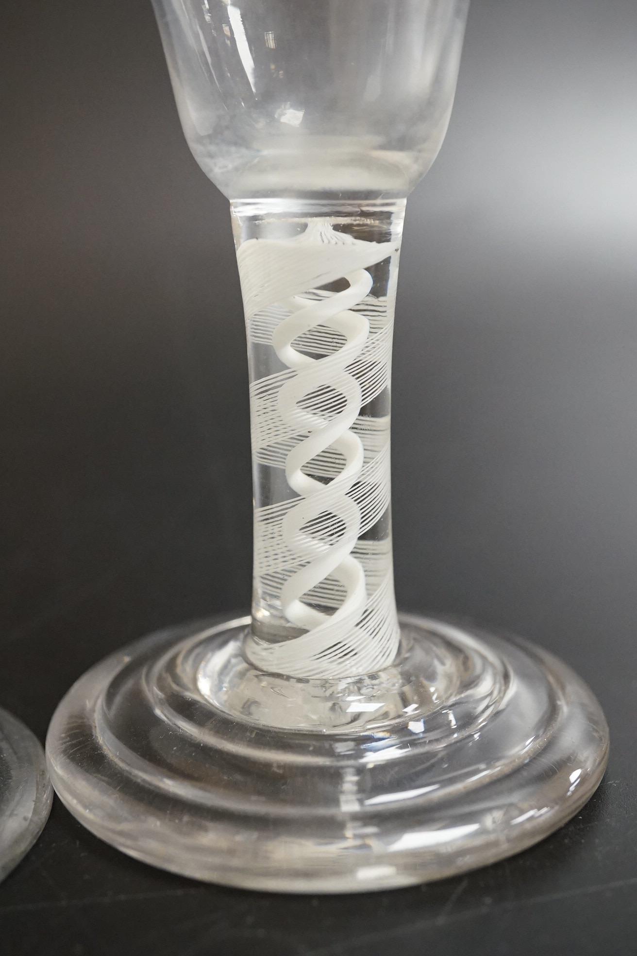 An opaque twist firing glass with terraced foot and a faceted wine glass with domed foot, c.1760, tallest 14cm